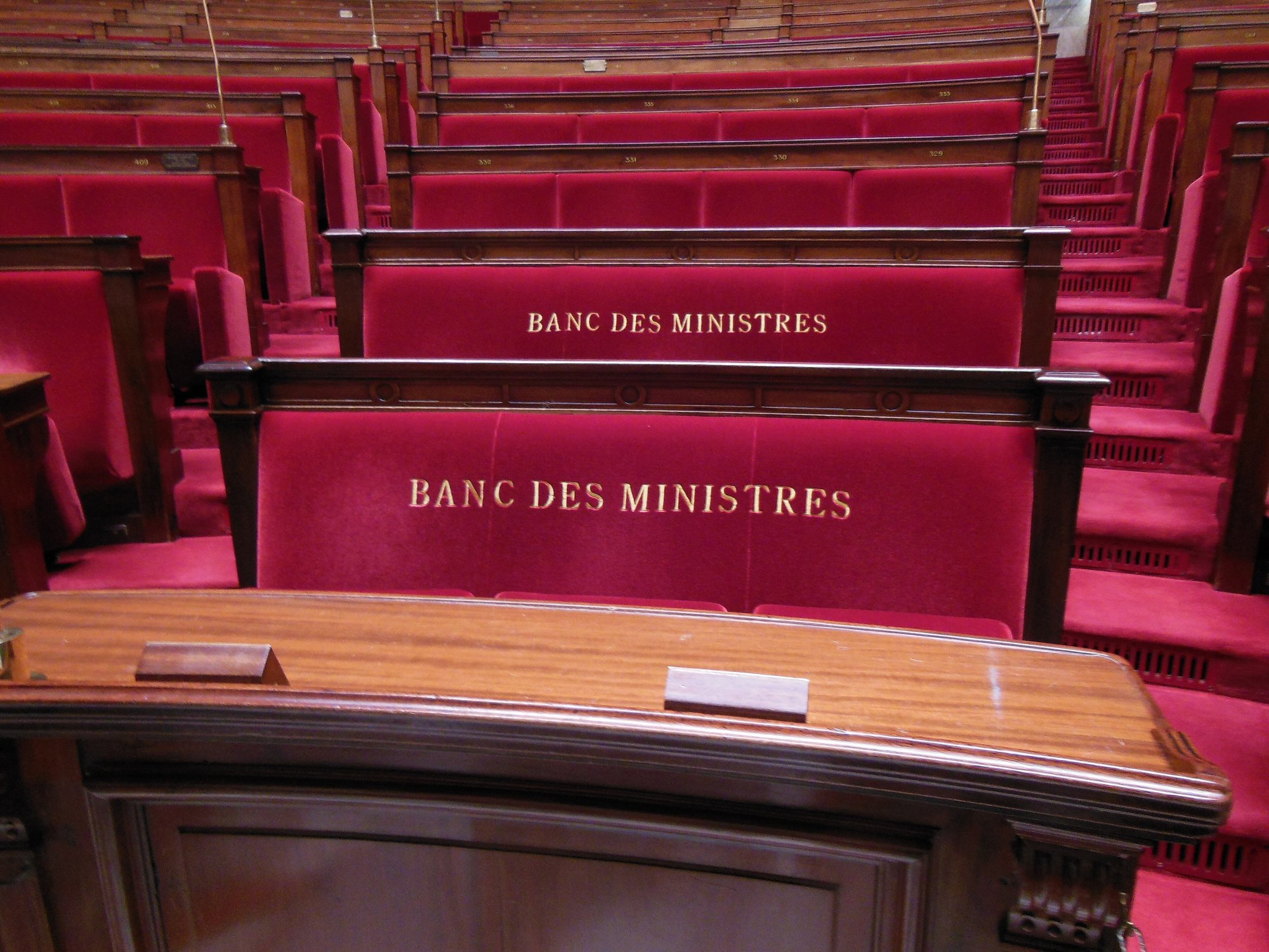 Red benches marked banc des ministres in the French National Assembly chamber