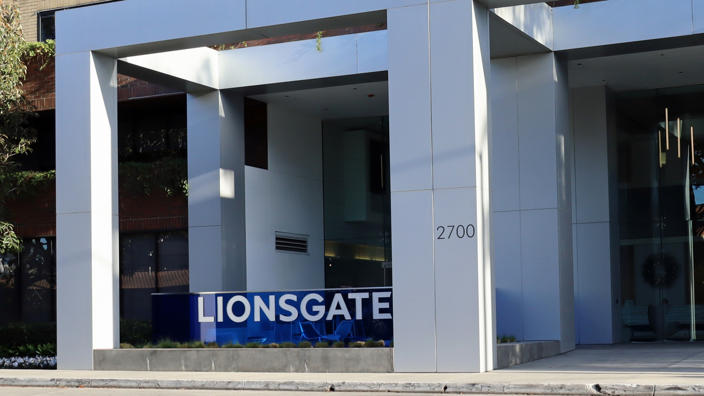 A blue Lionsgate sign in front of the white portico of a beige brick office building numbered 2700, on Colorado Avenue in Santa Monica