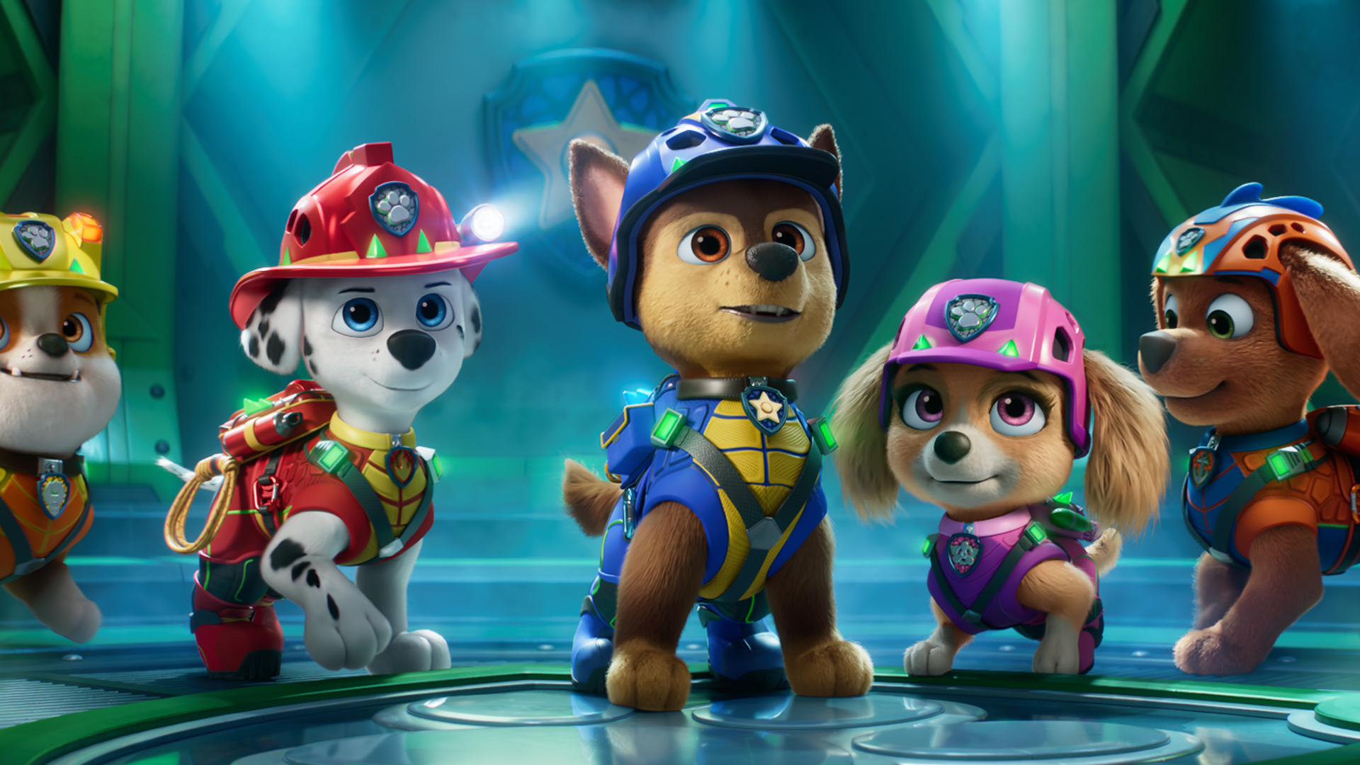 Rubble, Marshall, Chase, Skye and Zuma from PAW Patrol stand in a row in dino-rescue gear inside a teal-lit headquarters