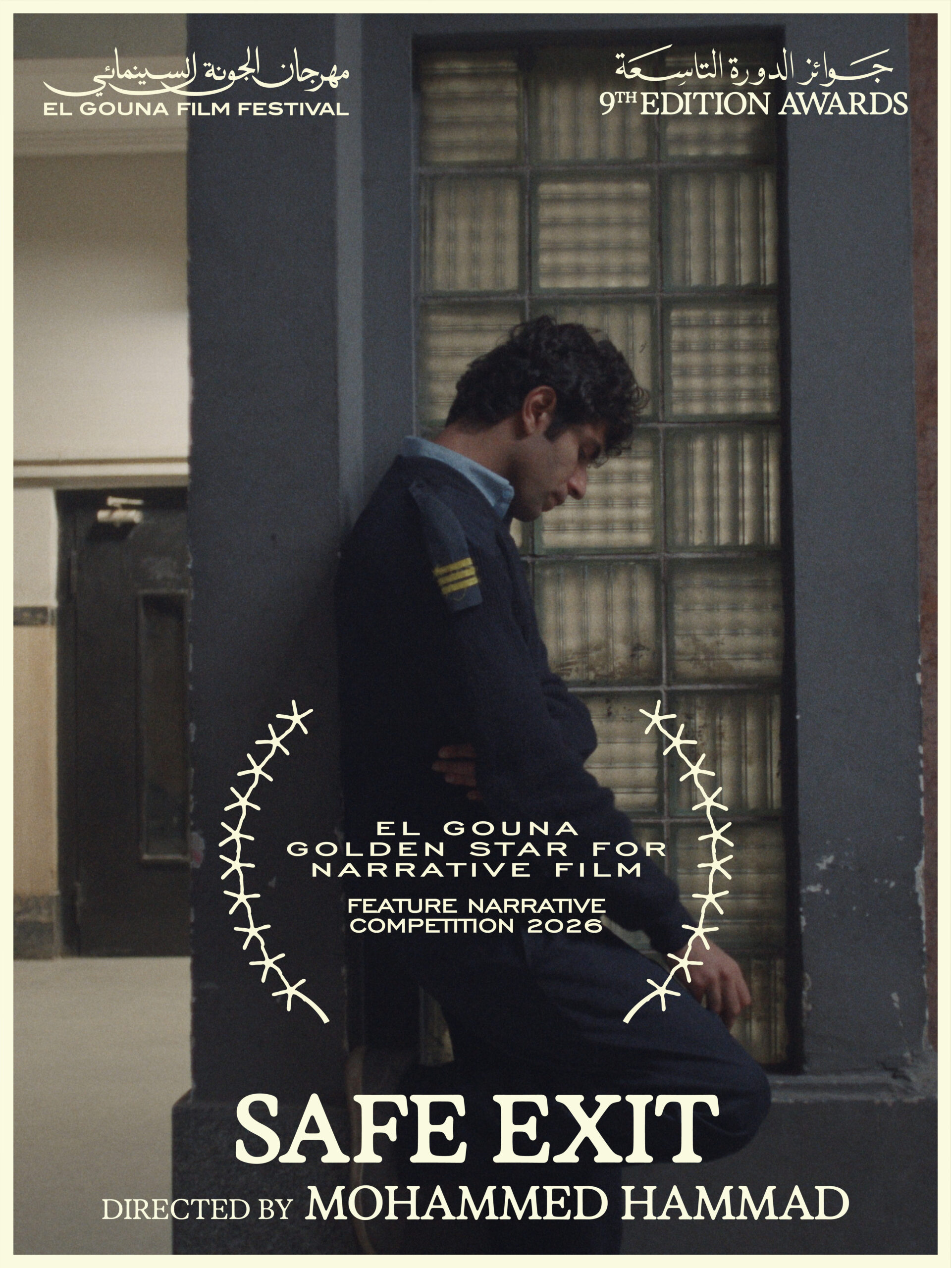 A young man in a guard’s uniform leans against a pillar beside a frosted glass window, under an El Gouna Golden Star laurel and the title Safe Exit