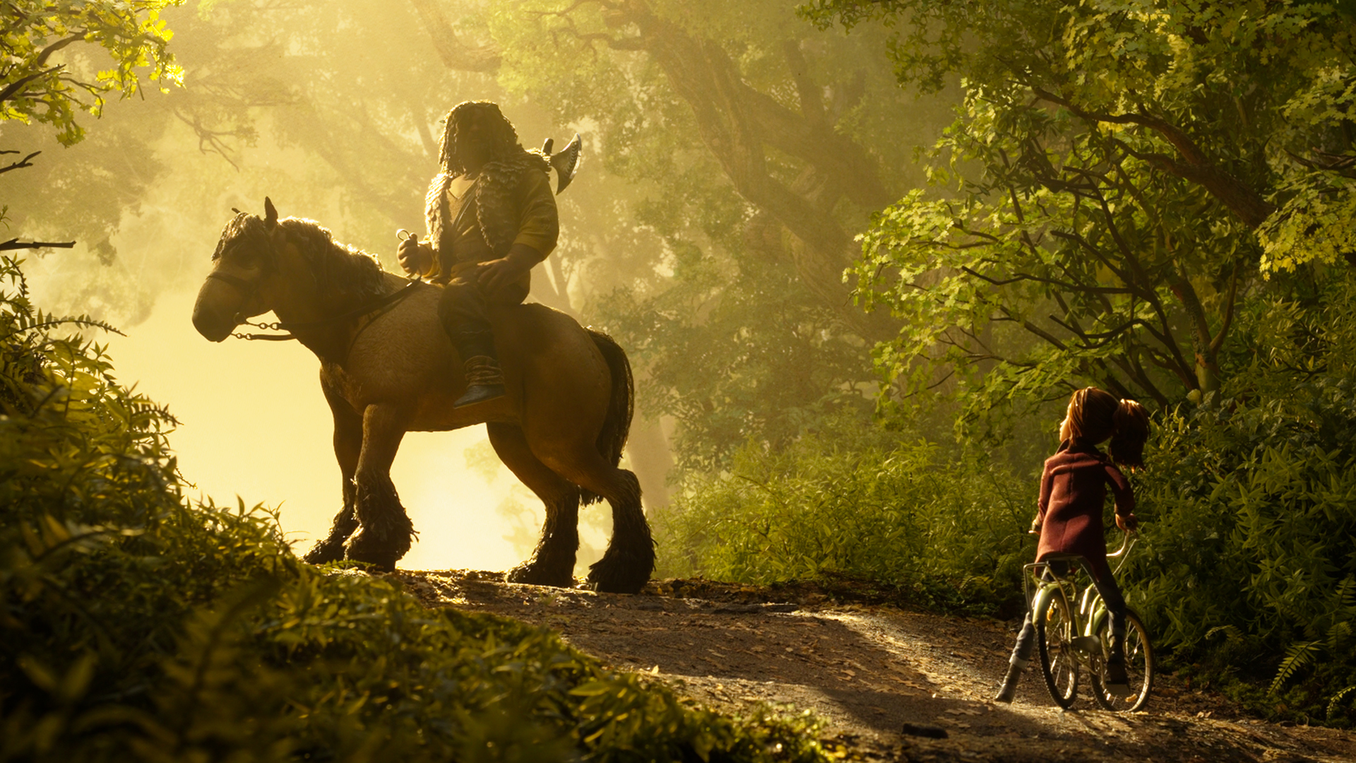 A girl in a maroon coat straddles a bicycle on a sunlit forest track, facing a rider on a large horse, in a stop-motion still from Wildwood