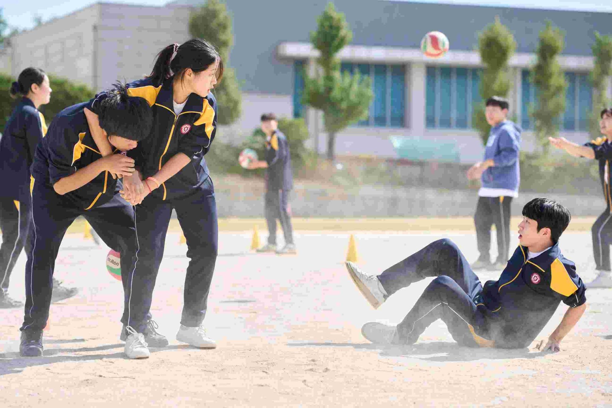 Students playing in a schoolyard in The World of Love